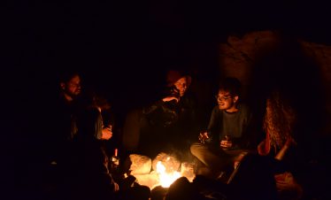 group of people camping at night